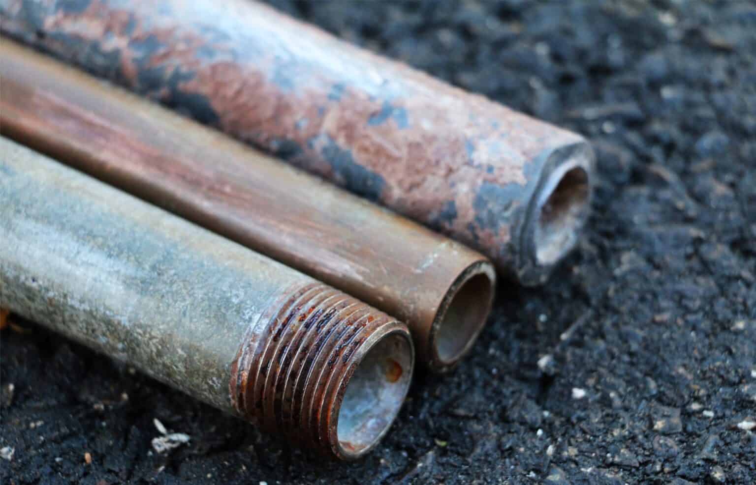 Corroded and rusted industrial pipes showing signs of significant deterioration and age — illustrating aging infrastructure challenges addressed through EDGE Engineering's environmental assessment, remediation, and compliance consulting services.