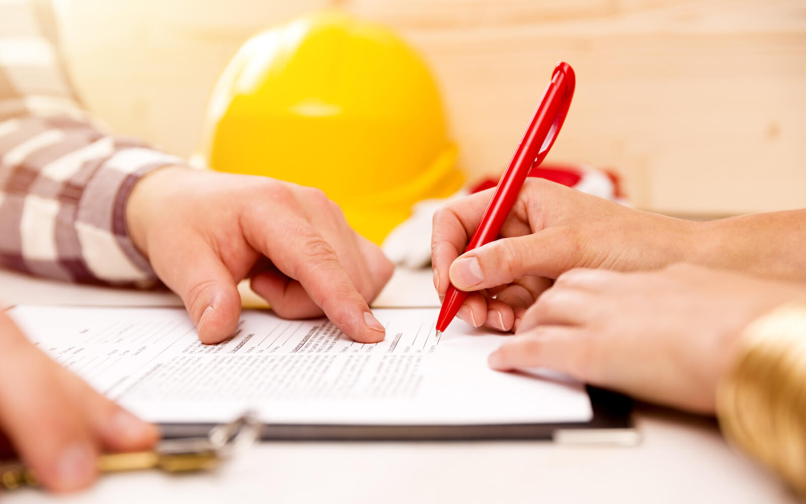 Signing Document With Roofing Adjuster For Insurance Claim
