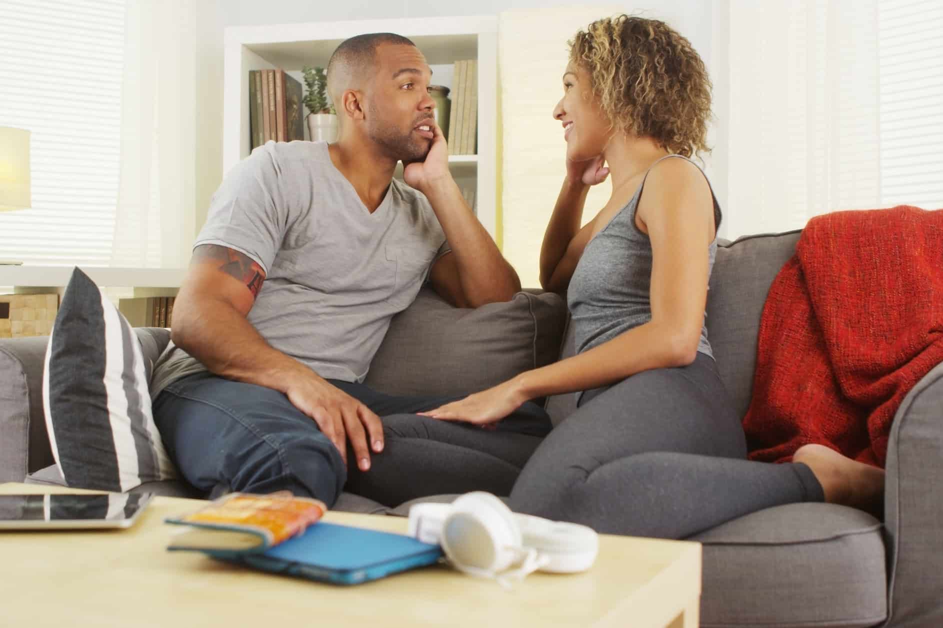 Couple sitting on a couch having a conversation