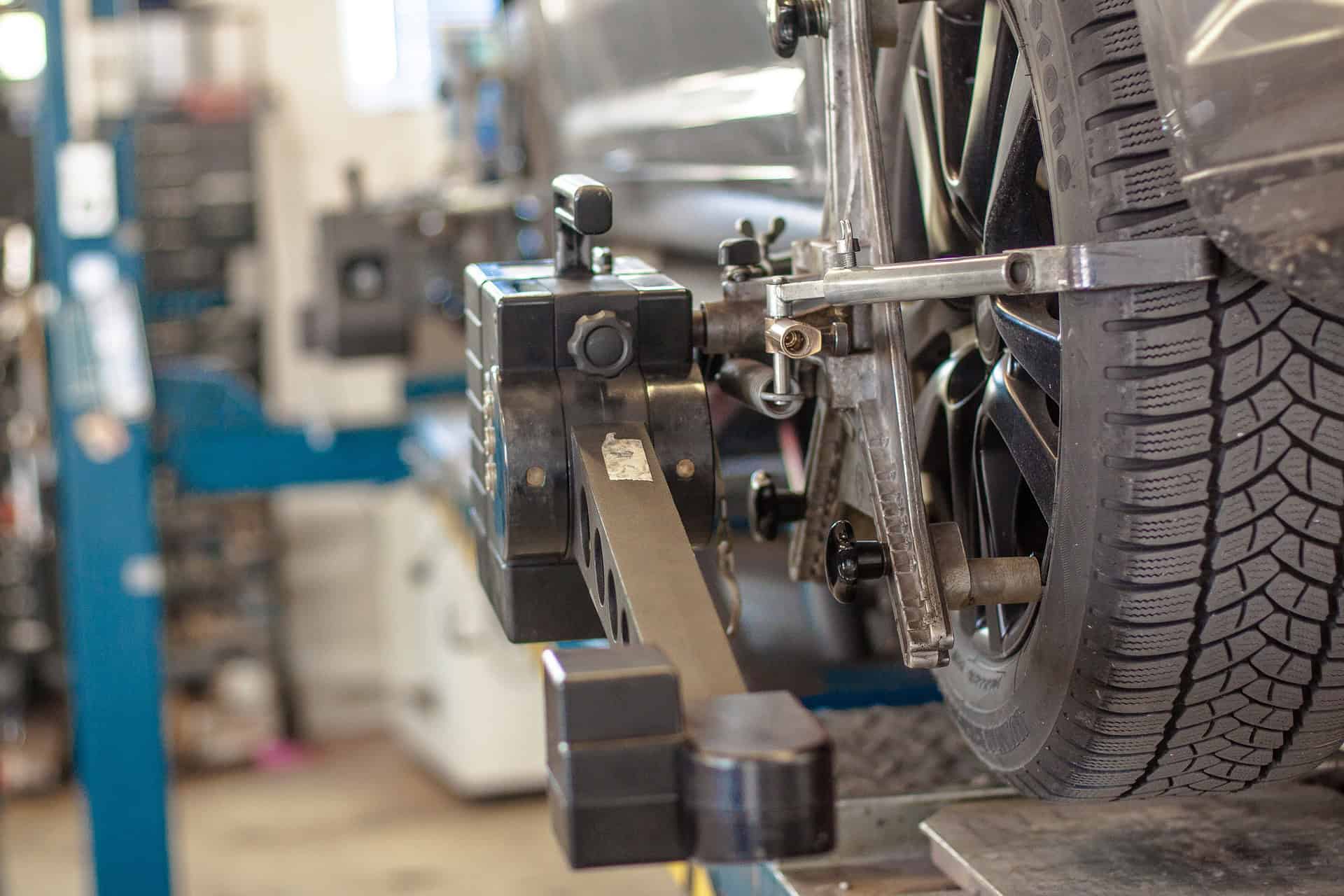 car in workshop having tyres aligned