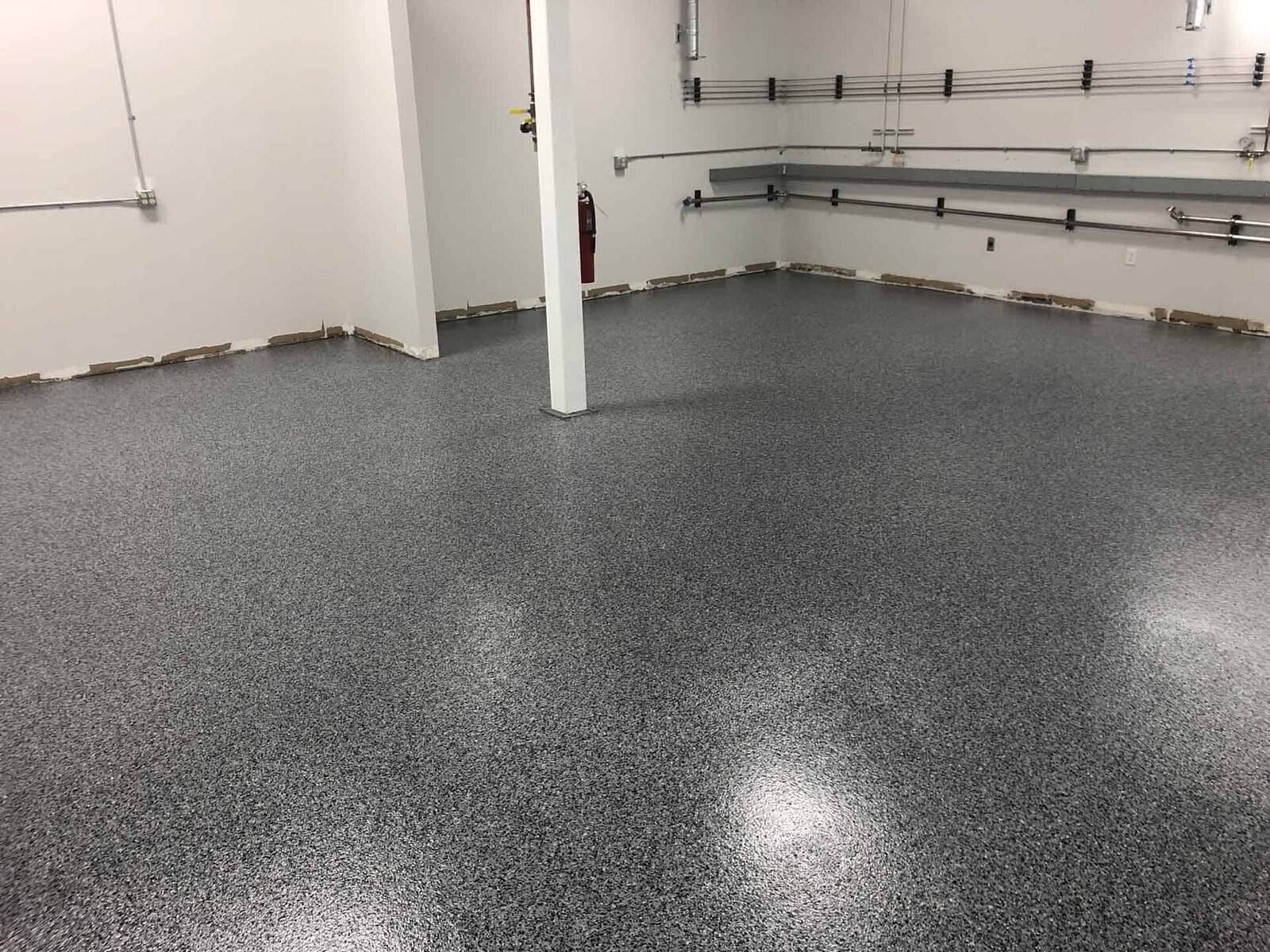 Polished epoxy-coated concrete floor in a commercial space, showcasing durable and attractive flooring solution by Minnesota concrete contractor.