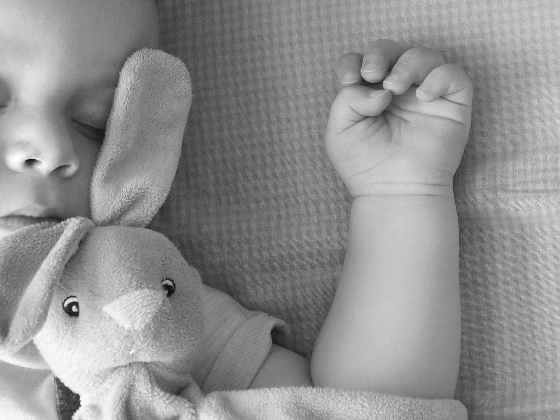 baby asleep in black and white image