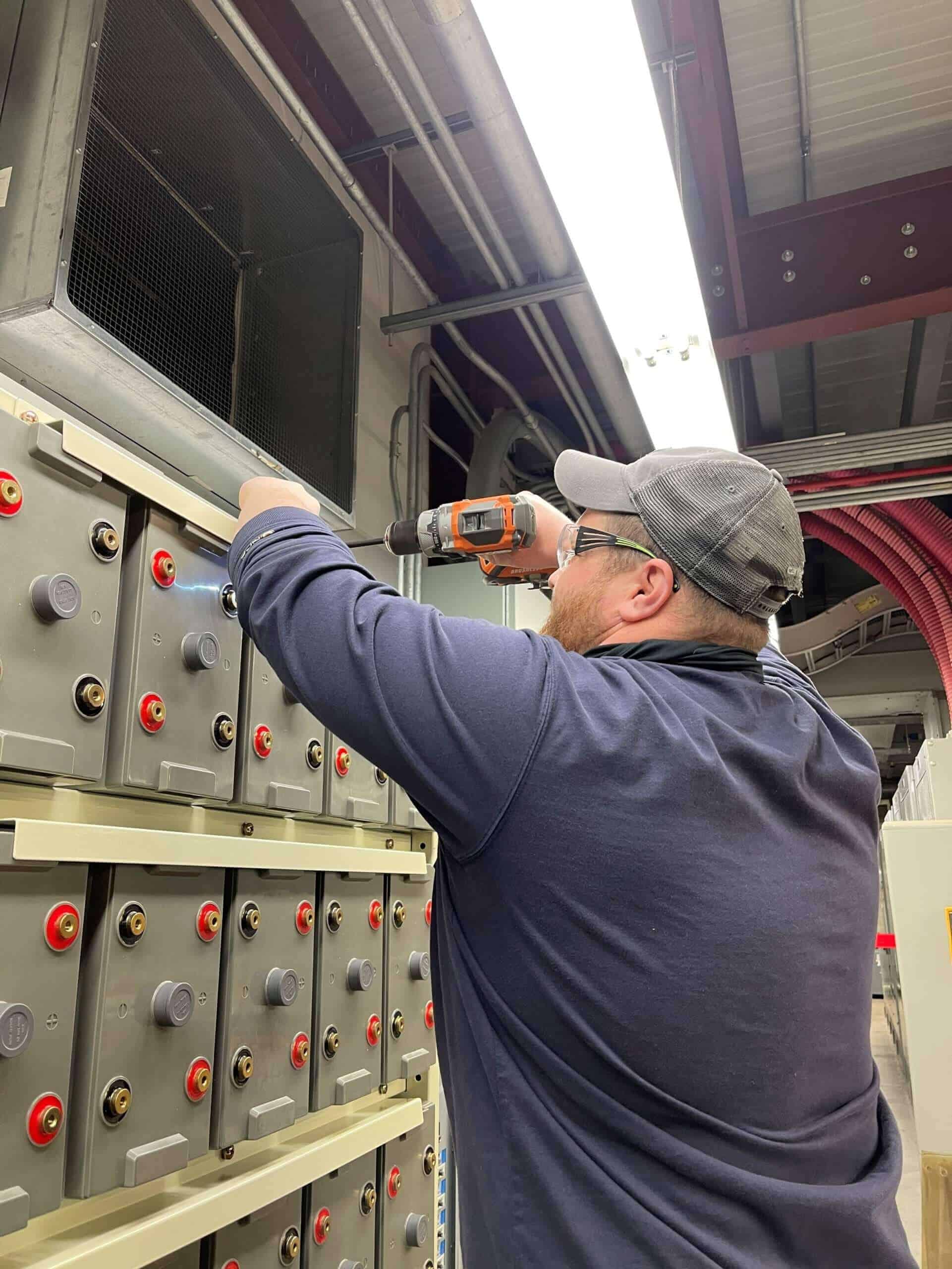 Eagle Eye Power Solutions battery service technician installing a battery system