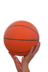 Hand and basketball ball isolated on white