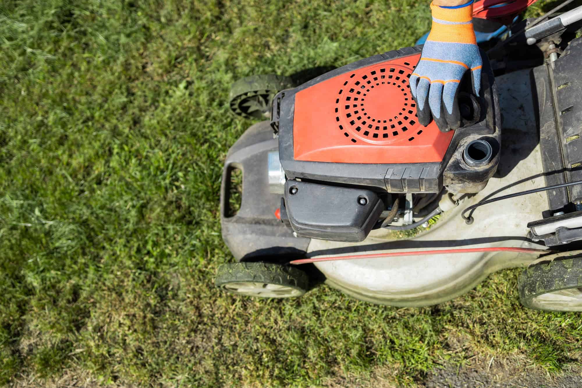 Gardener opened the mower's fuel filler neck