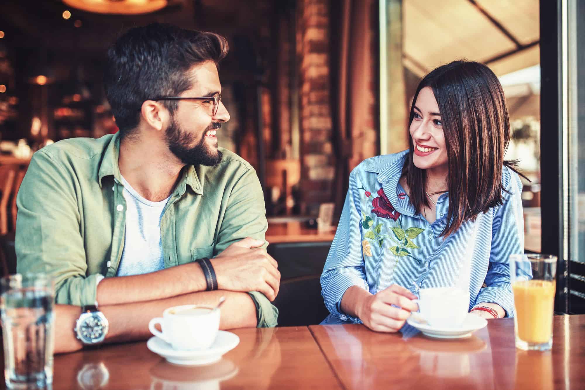 Happy couple enjoying a coffee date after applying the 10 tips fora. great first date.