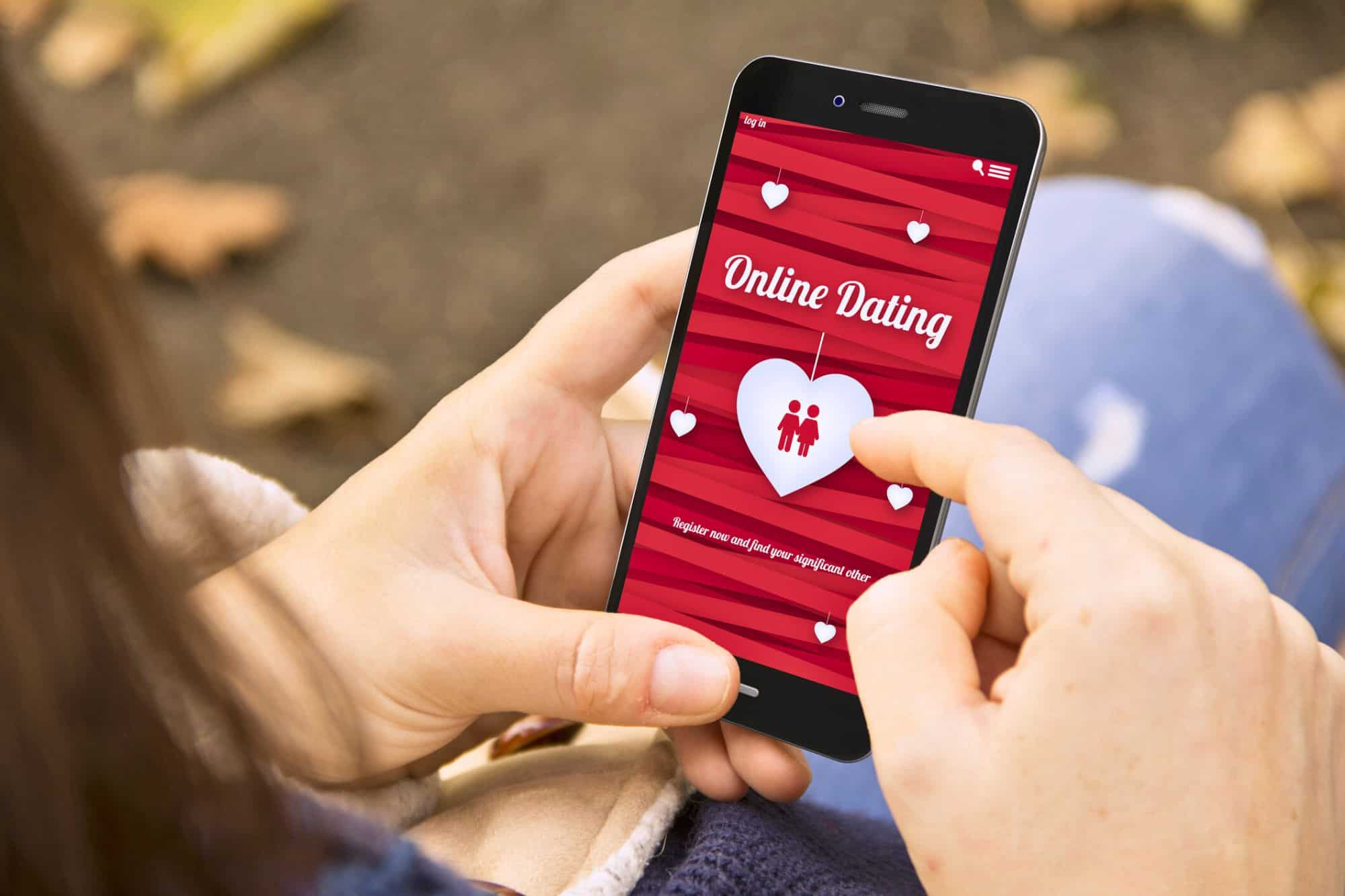Woman looking at her online dating app on her phone during cuffing season.