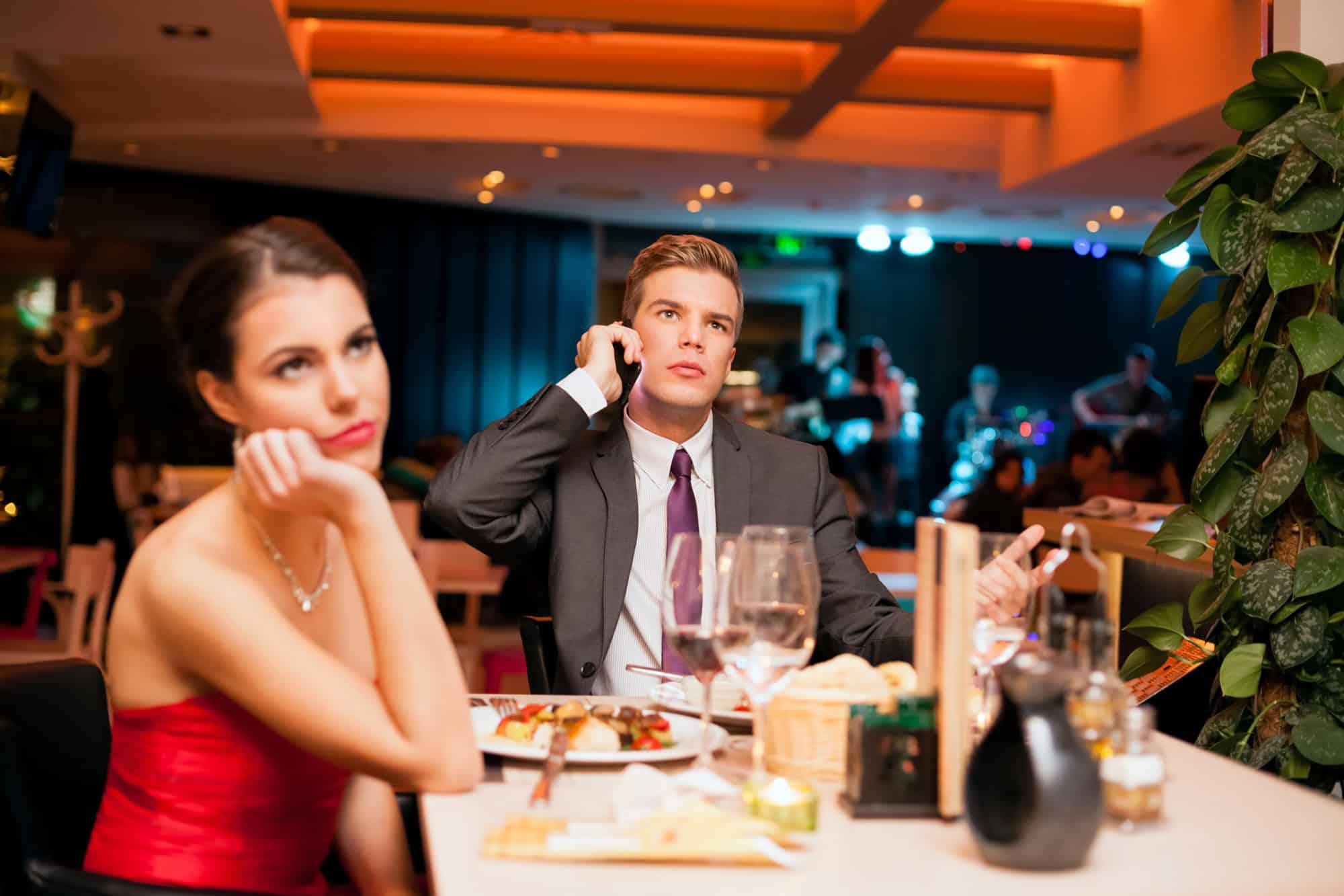 Woman on a dinner date looks bored and offended by rude date as she sees the red flags in this new relationship.
