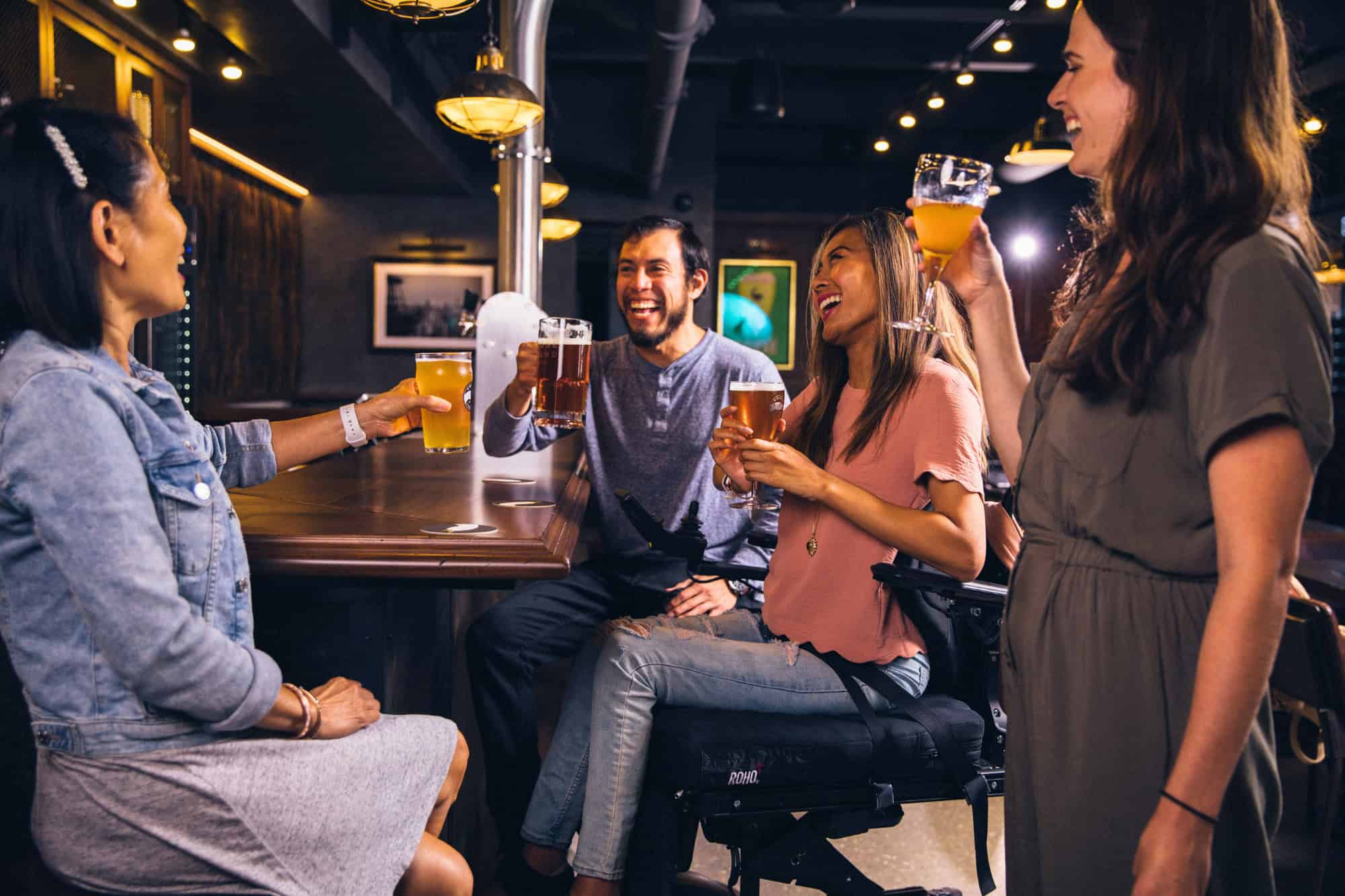 A man in a bar surrounded by too many women who have realized this is not one of the best ways to meet singles.