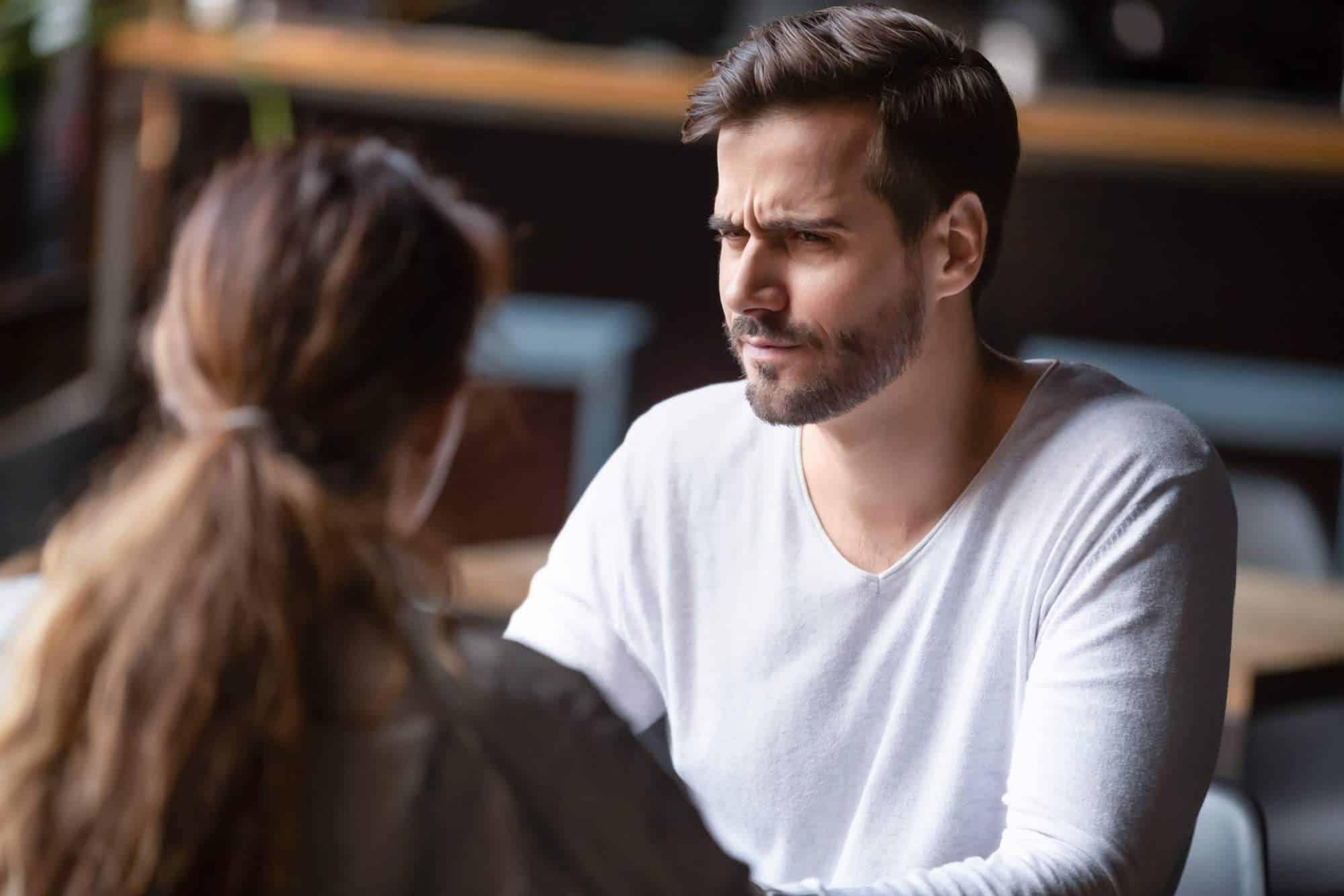 Man looking quizzically at his date when he hears her marital status