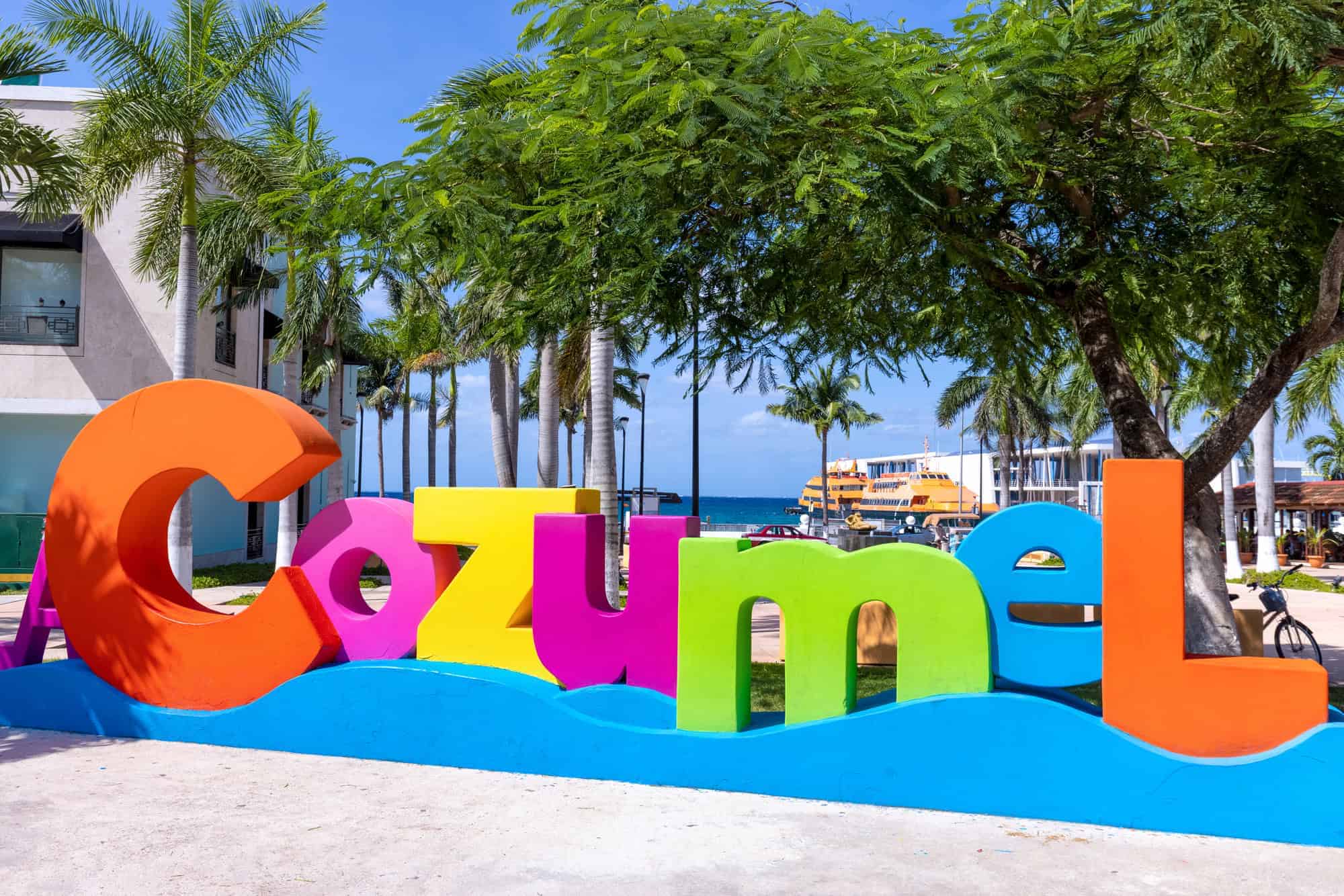 Colourful Cozumel Sign Colourful Cozumel sign with palm trees and the ferry port in the background