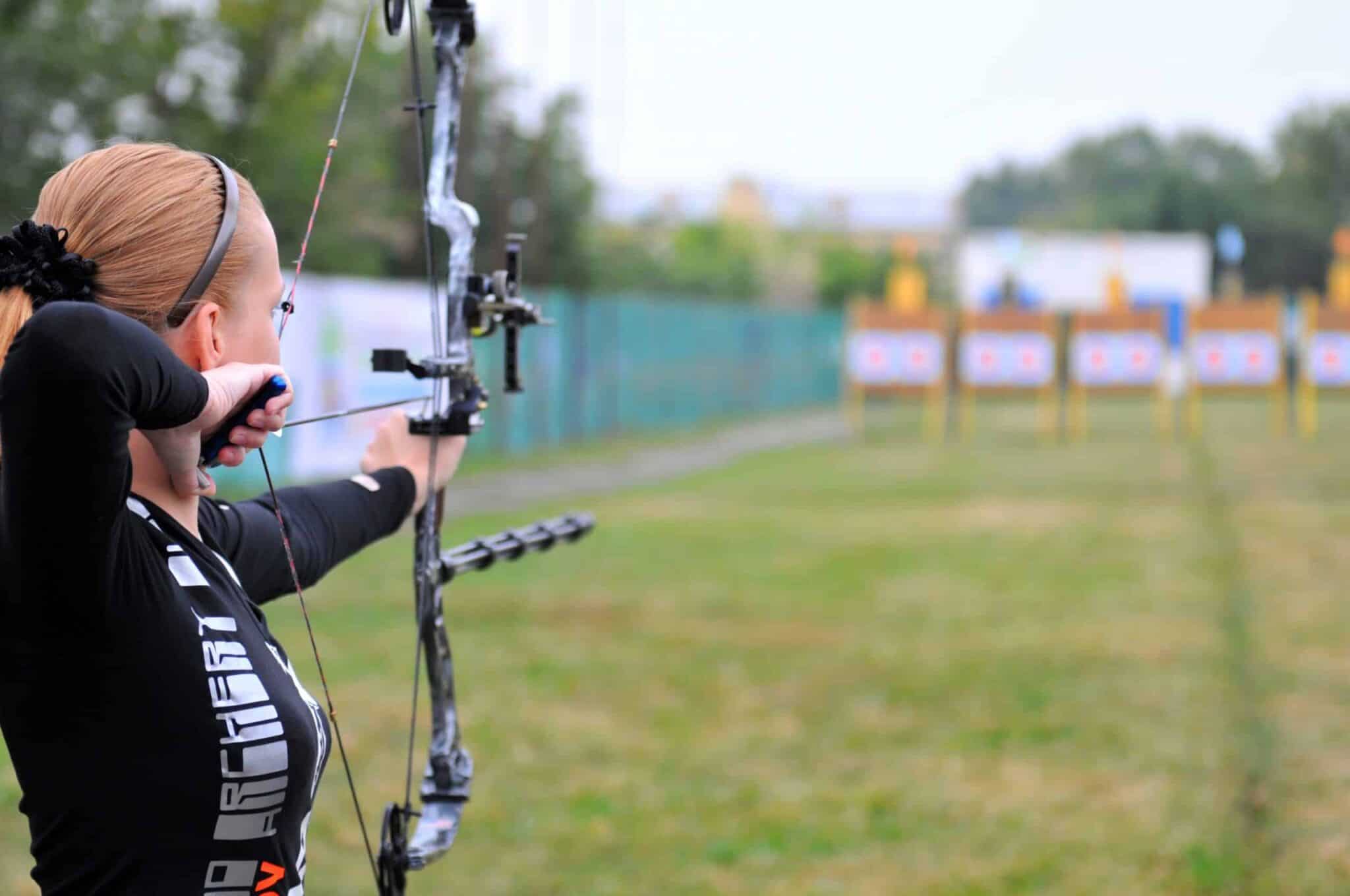 Person with bow and arrow aiming at target