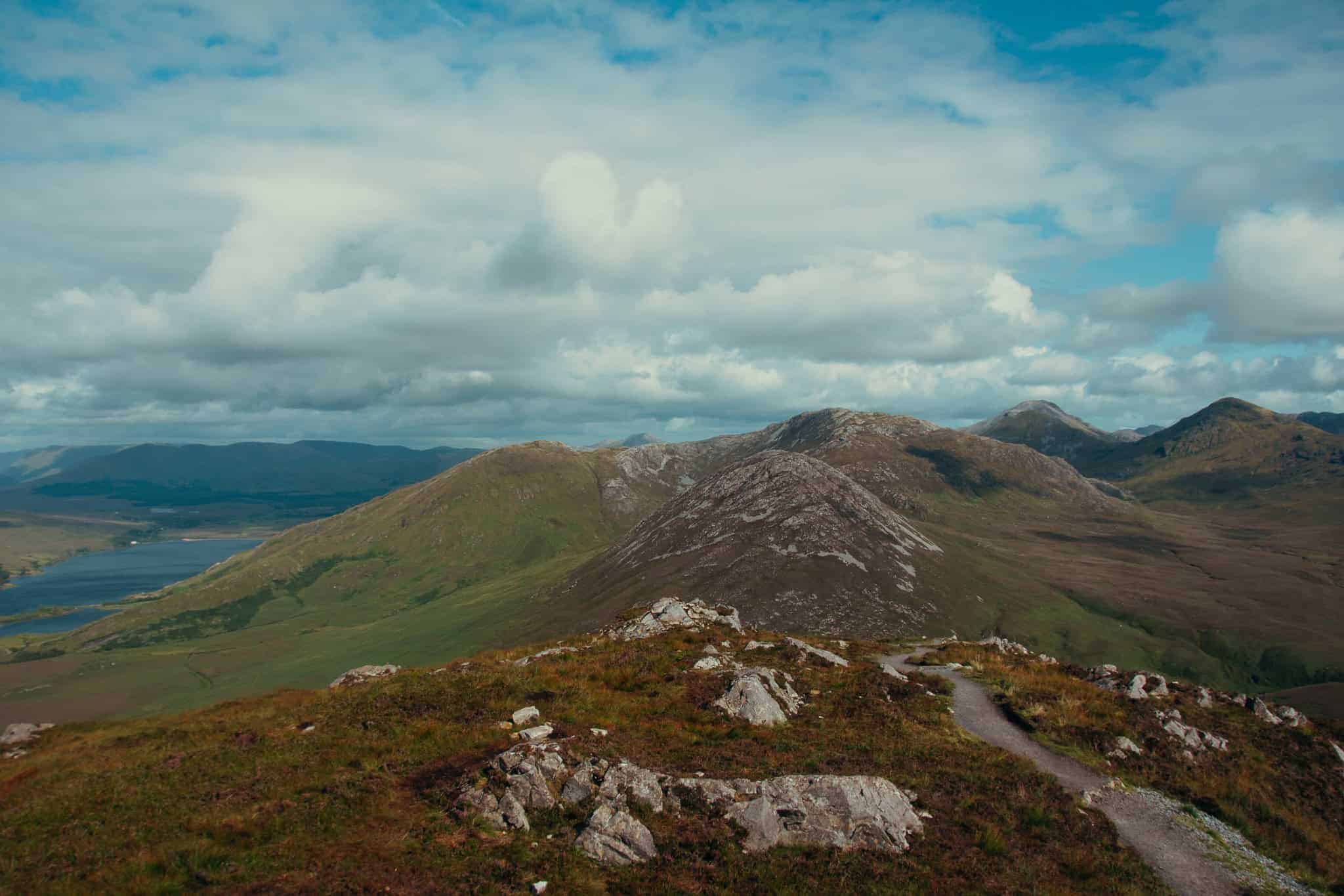 A panoramic view from the summit of Diamond Hill, showing the rugged landscape and rolling hills of Connemara.