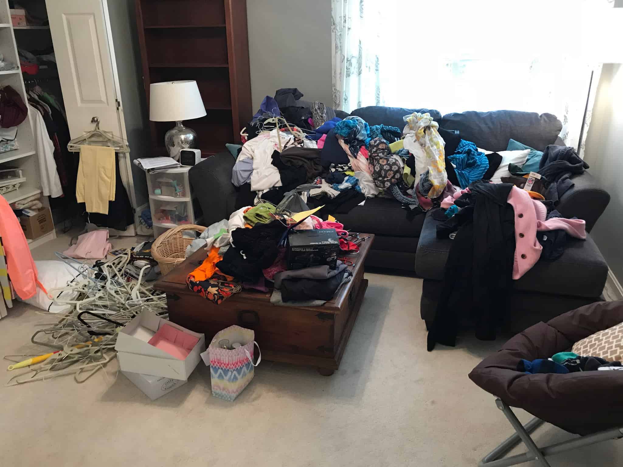 piles of clothing on couch before organizing session