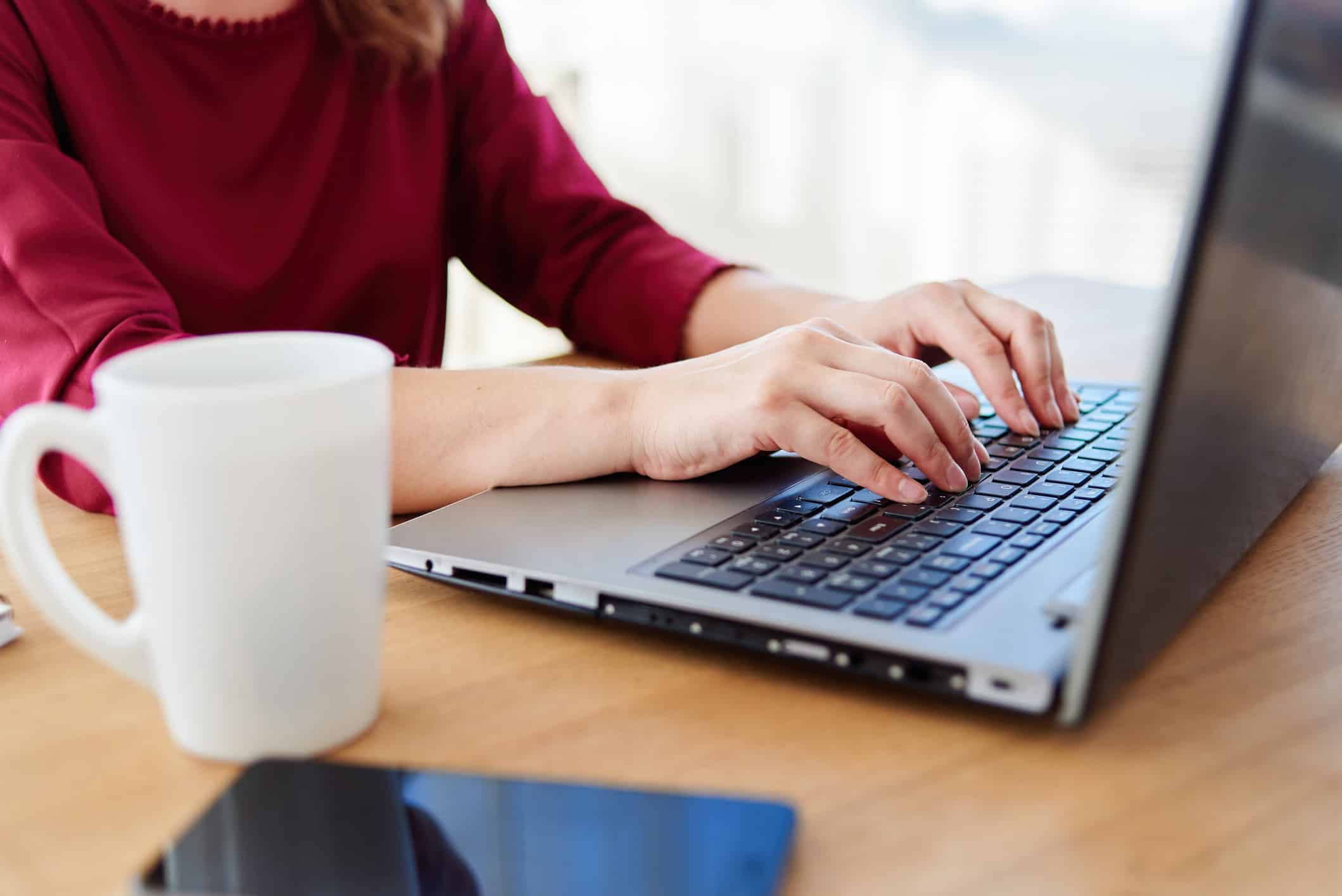 Online dating ghostwriter at work on their laptop.