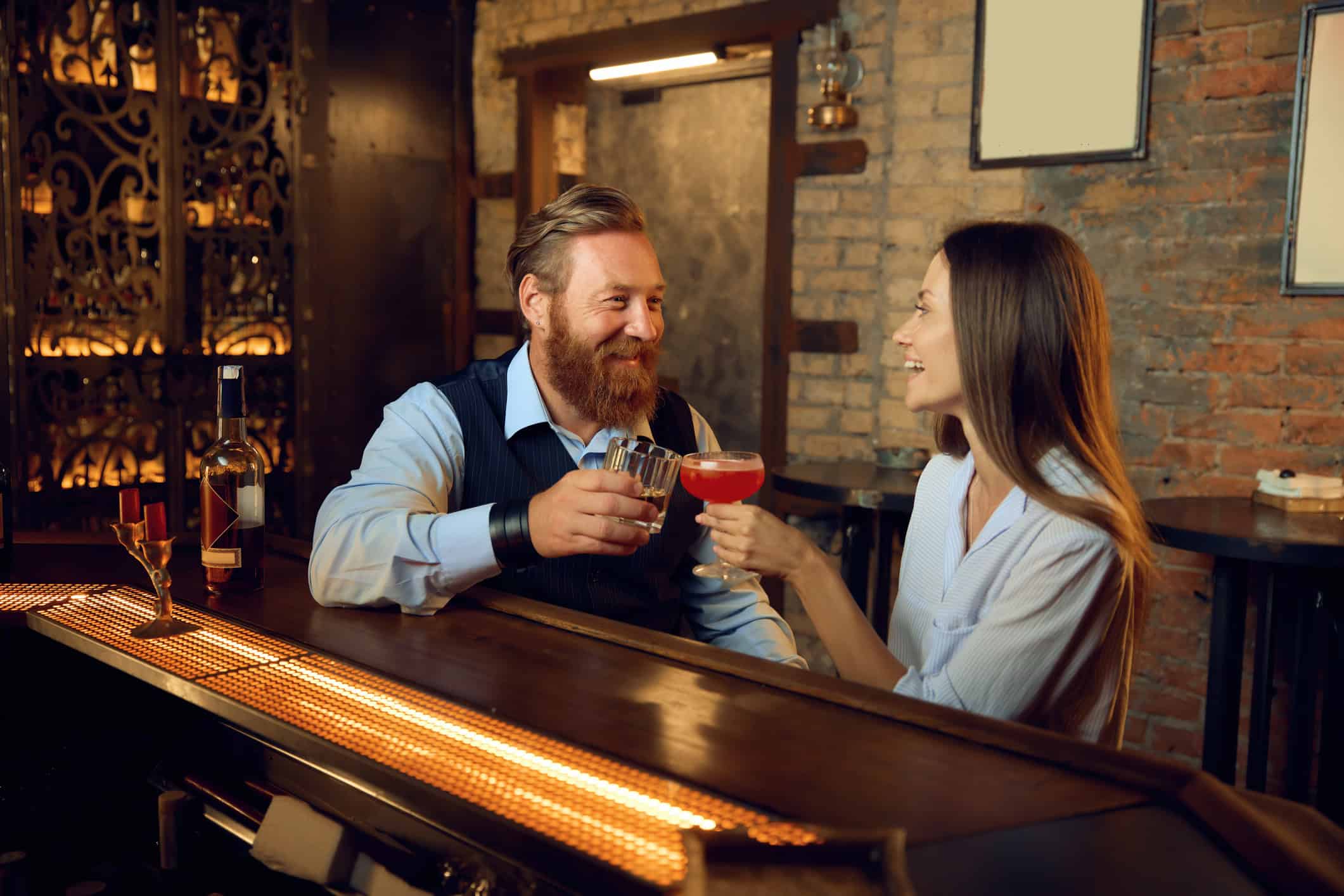 A middle age couple dating after divorce, in a bar trying to connect.
