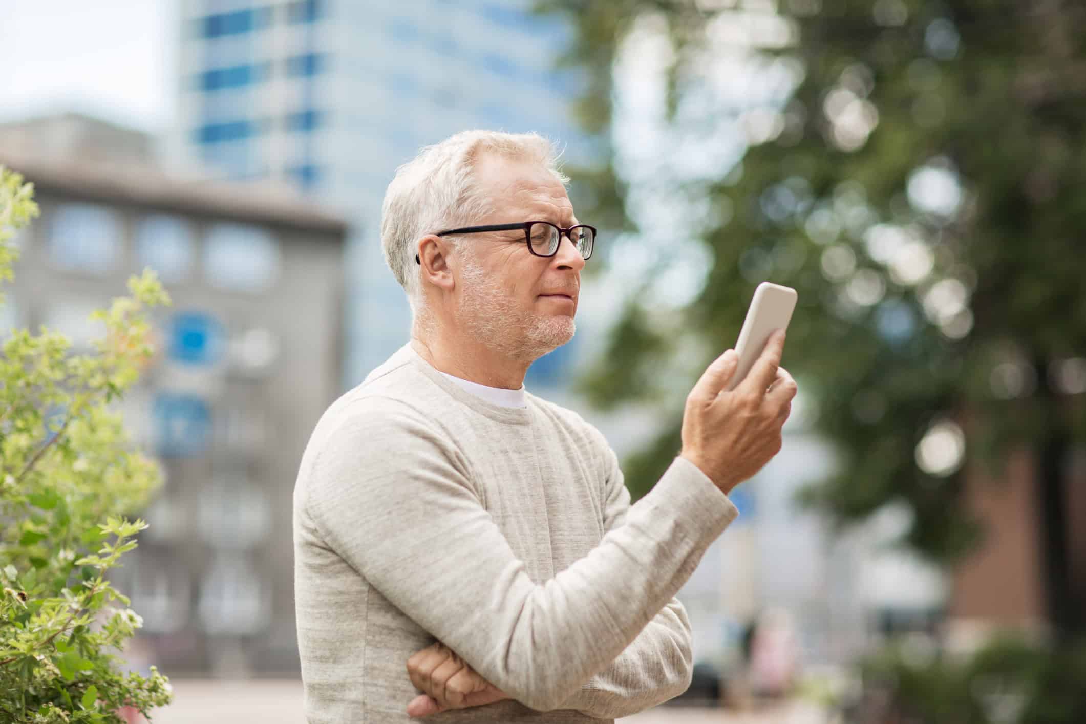 Man looking at his latest online dating chat and wondering if it's time to ask for a date.