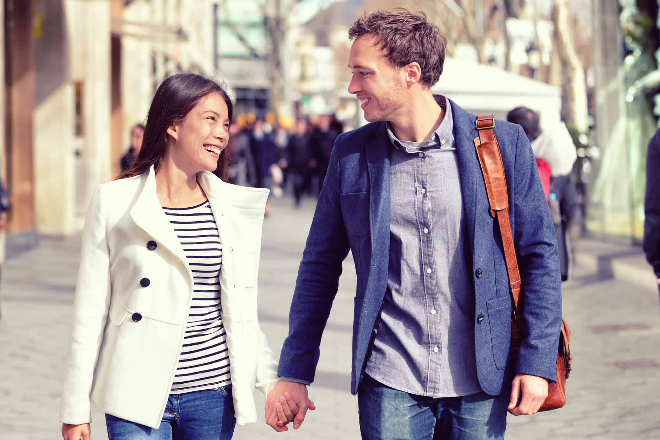 Couple who found their own true love holding hands and looking at each other.