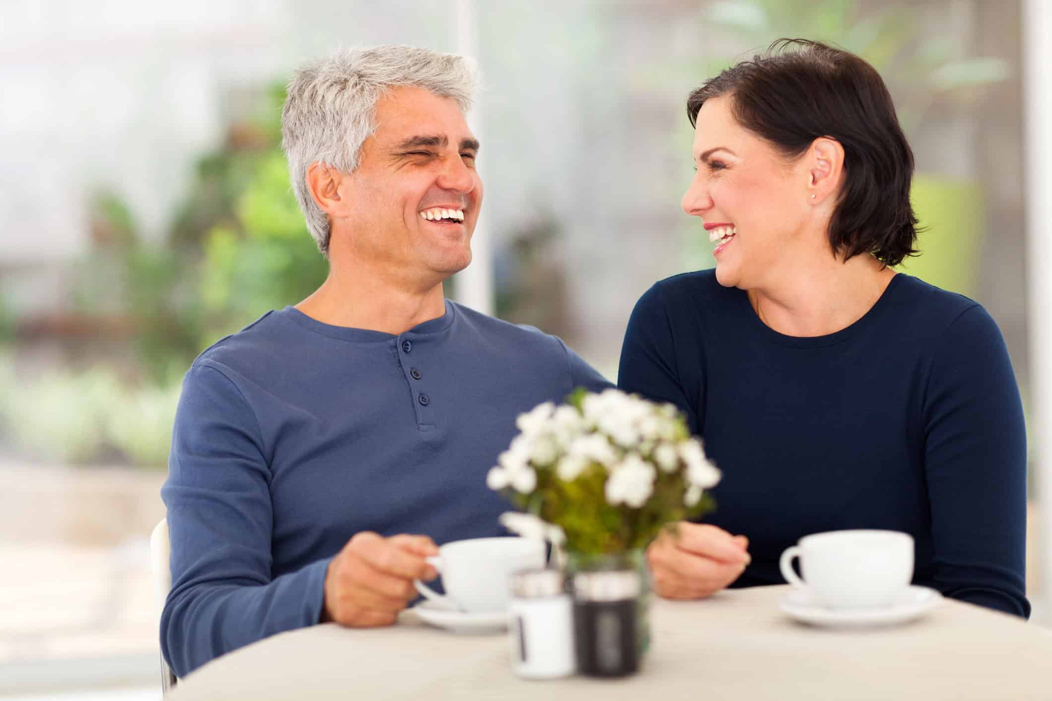 A middle-aged man and women enjoying coffee together as they begin a new relationship, finding love after divorce.