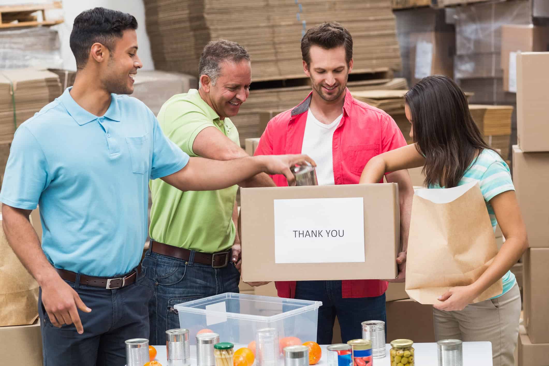 A group of people, including marriage-minded men, happily volunteer to pack meal kits.
