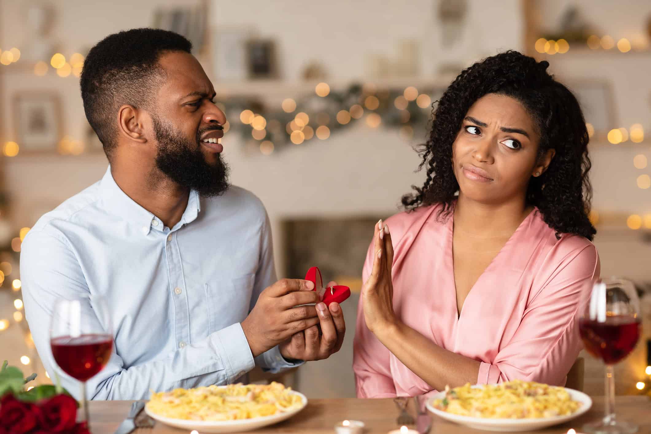 A confused-looking man proposing to a skeptical woman who is wondering what to do when a guy talks about marriage too soon!