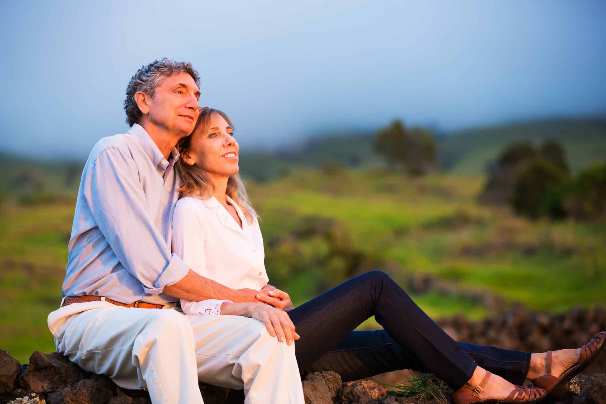 A couple who dramatically improved their luck of finding love after 50 lounging together outside watching the sunset.