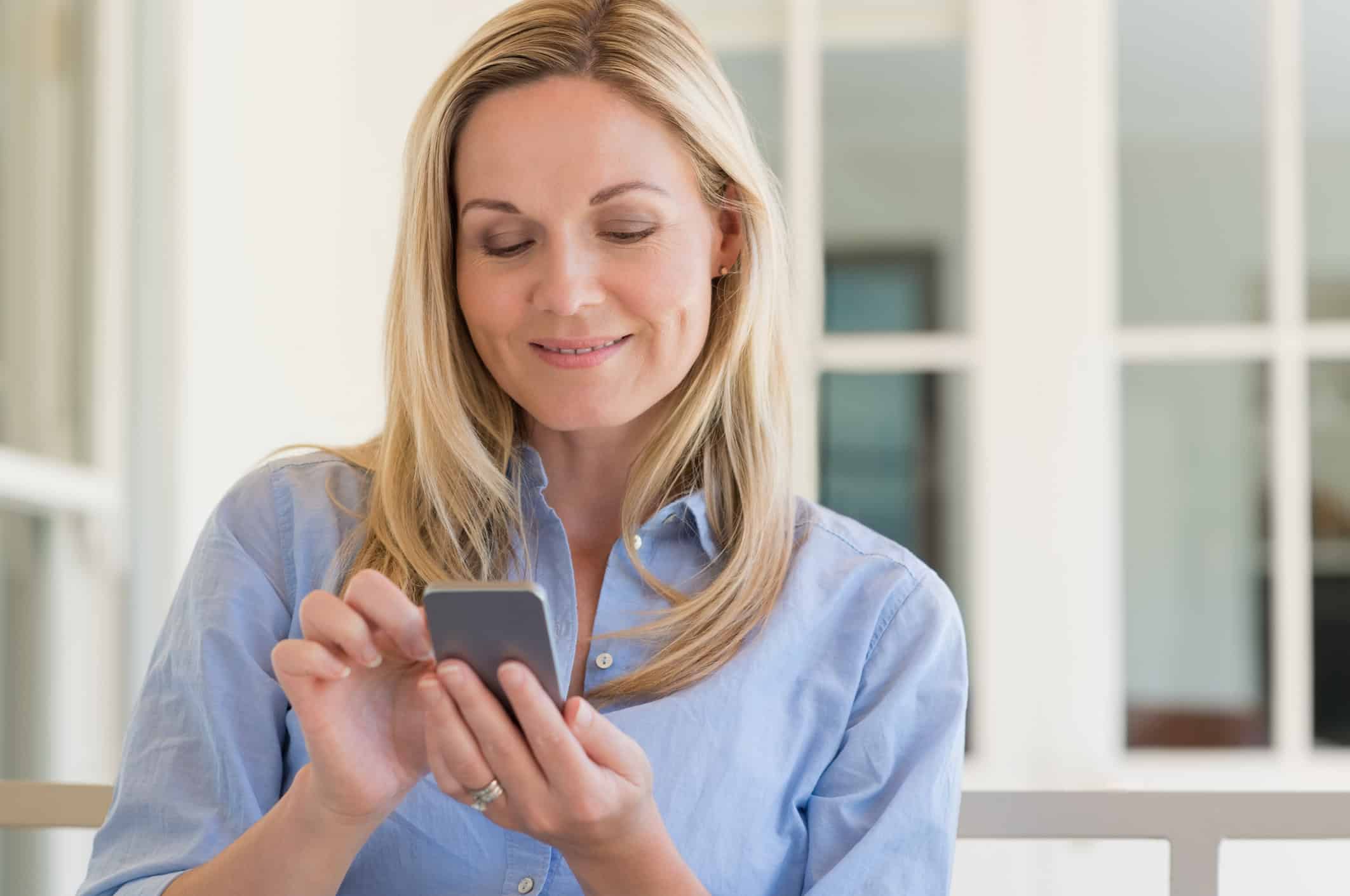 Woman learning the online dating rules as she looks at the app for a match