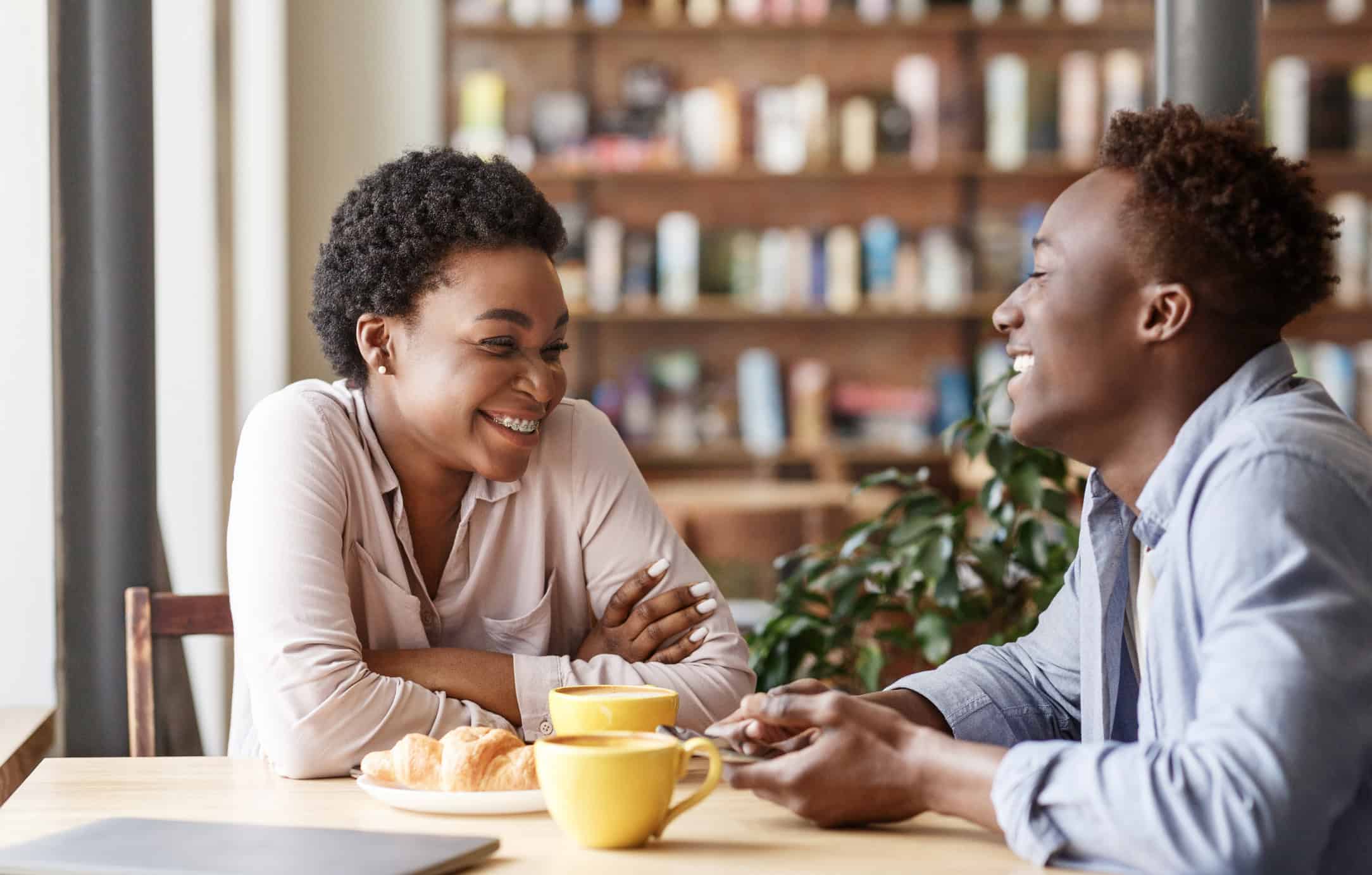 Couple having a great first date over coffee is the result of great dating strategies.