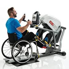 Man in wheelchair using adaptive exercise machine