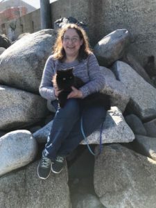 woman and persian on rock wall