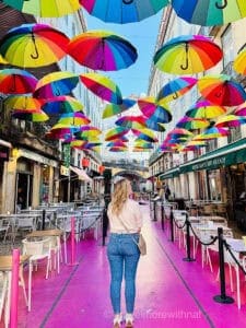 Pink Street in Lisbon has a pink path and colourful umbrellas suspended overhead, and is the perfect photo stop on any intense day tour of Europe.