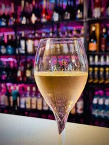 A colourful bar scene and a glass of Cricova wine