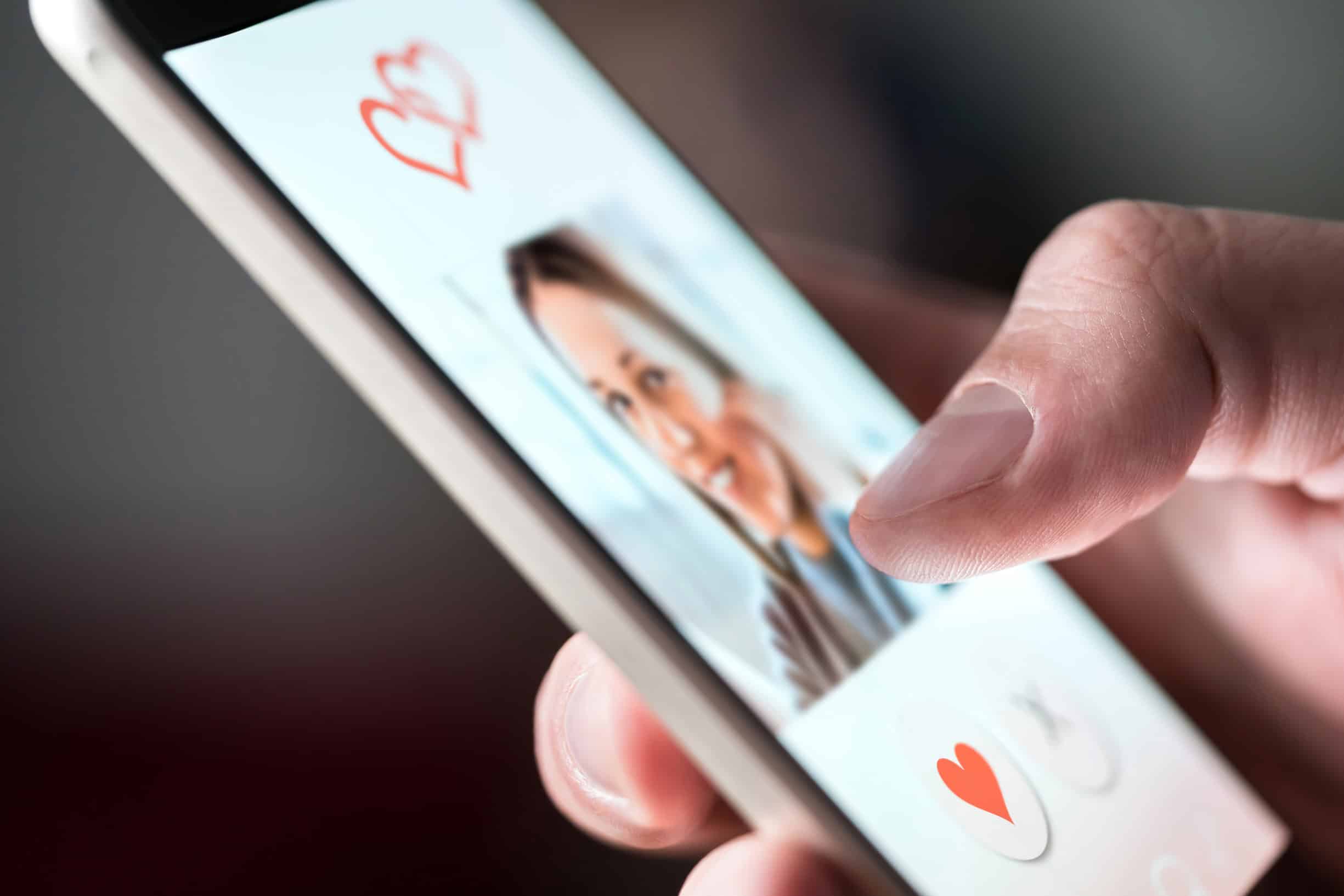 Man looking for success with online dating as he reviews a woman's profile.