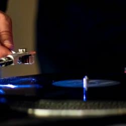man playing record on a turntable