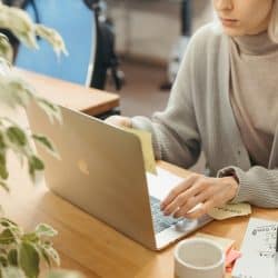 woman checks her email in office.