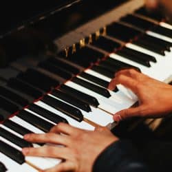 closeup of pianist's hands on piano