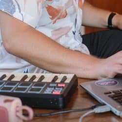 man producing music in at-home studio environment