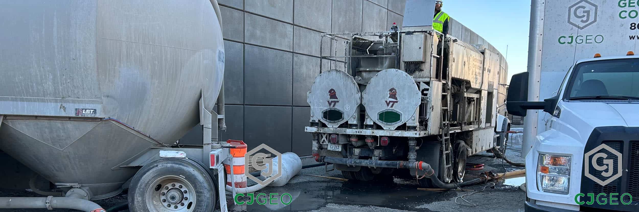 CJGeo's specialized grouting equipment, including a mobile plant and cement tanker, set up next to a railroad T-wall in Boston.