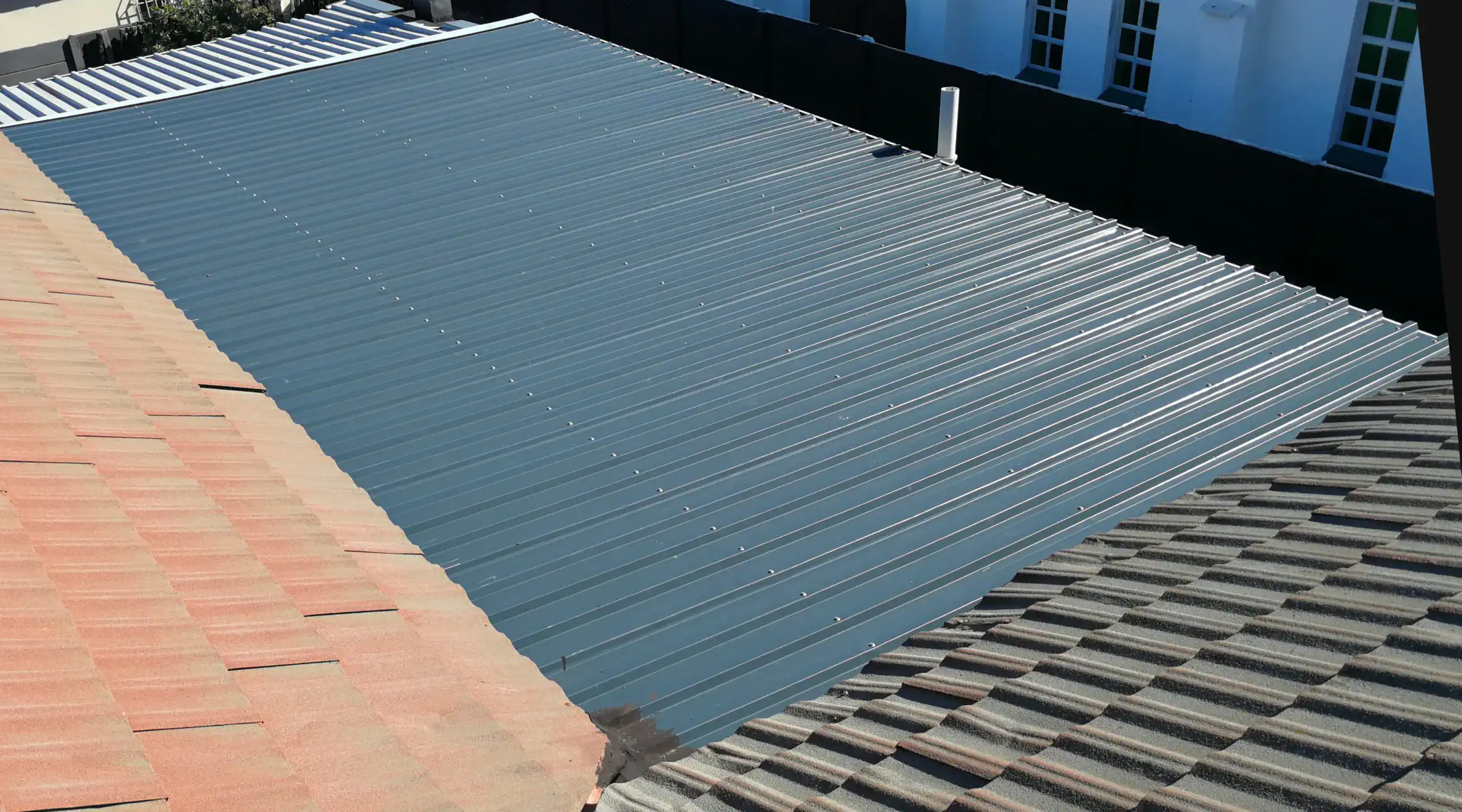 Precision-fitted industrial charcoal roof sheets installed for a residential property in Cape Town.
