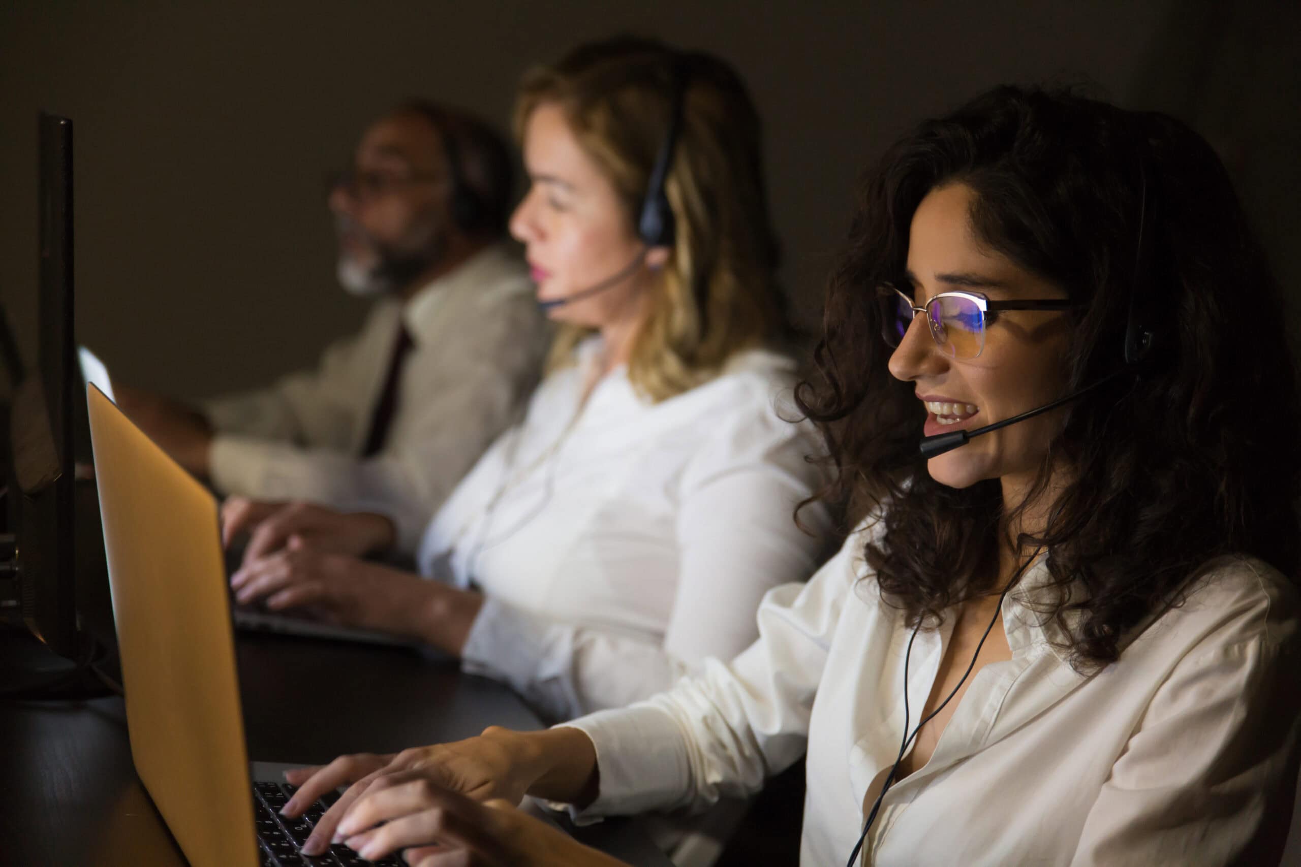 Customer service workers in dark office
