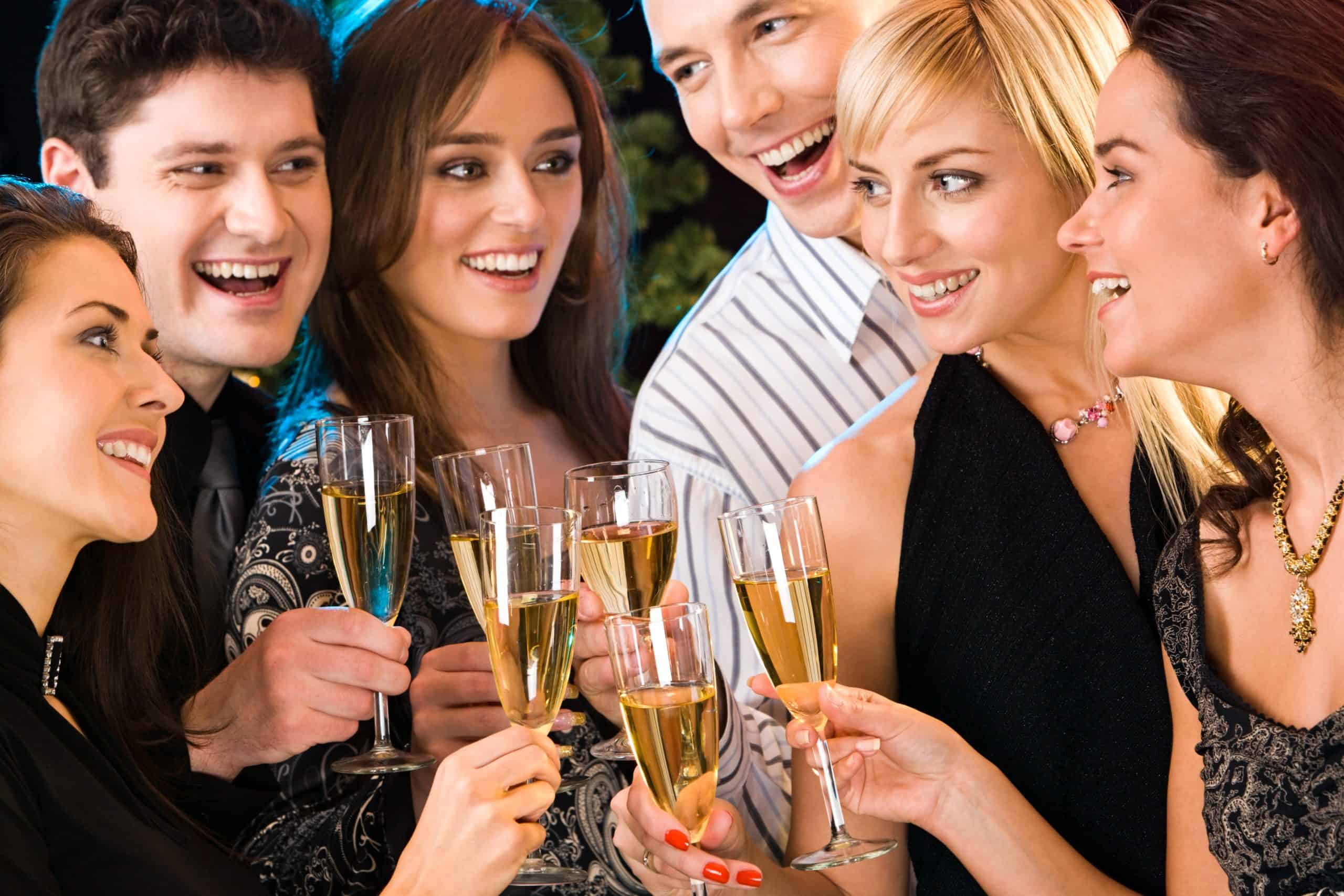 Portrait of six happy people holding glasses of champagne making a toast