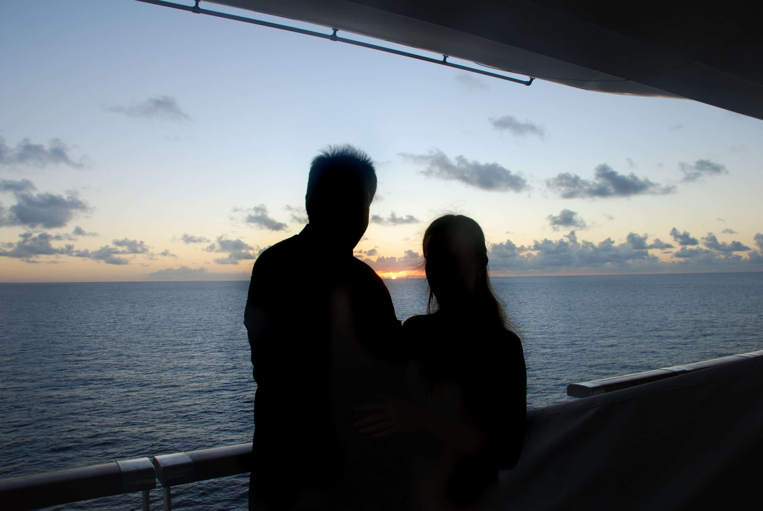 A couple overlooking the ocean on a cruise who met and connected while traveling with singles groups.