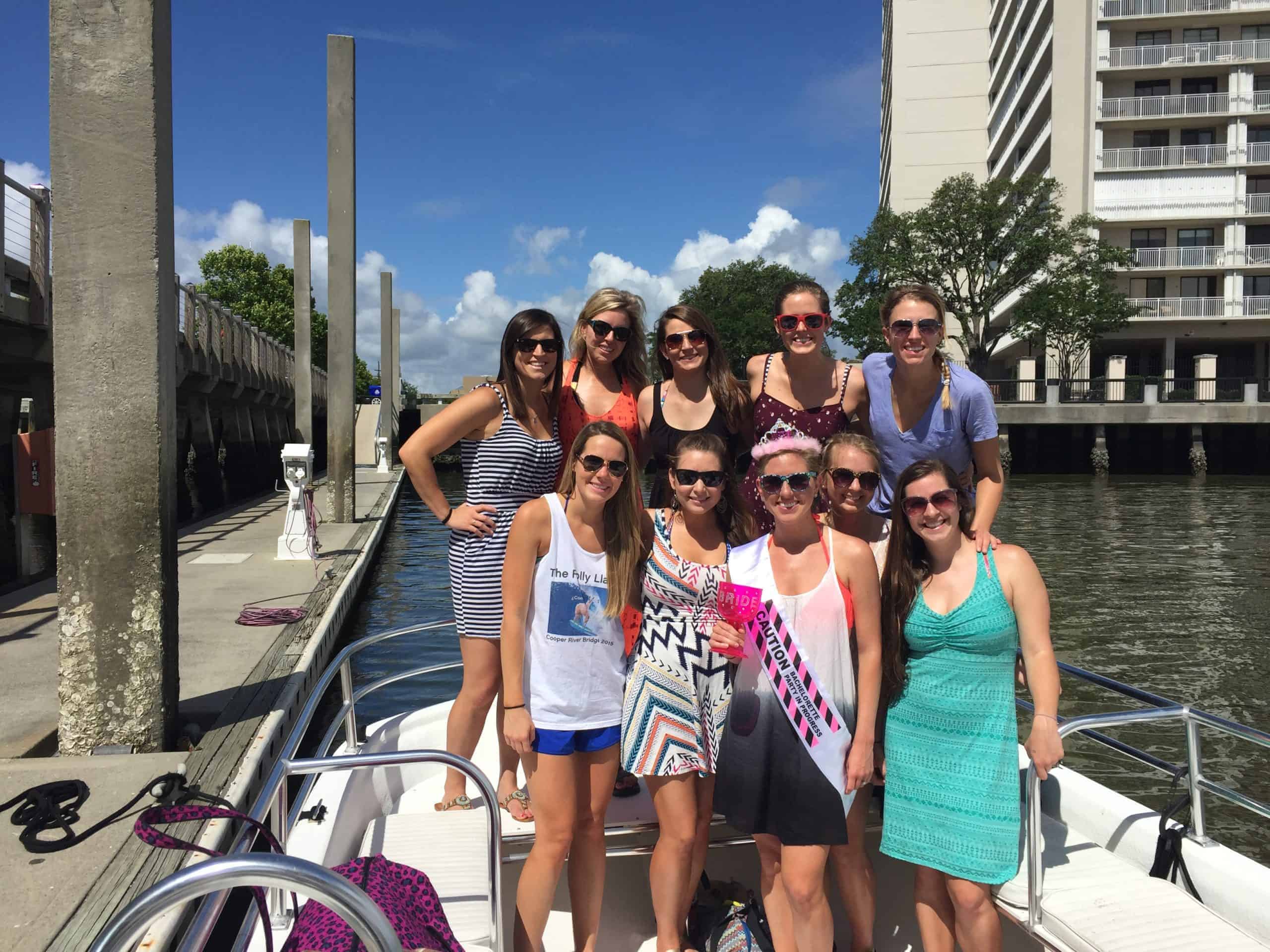 Group of women taking a picture before they go out on their adventure on the boat. Charleston booze cruise bachelorette