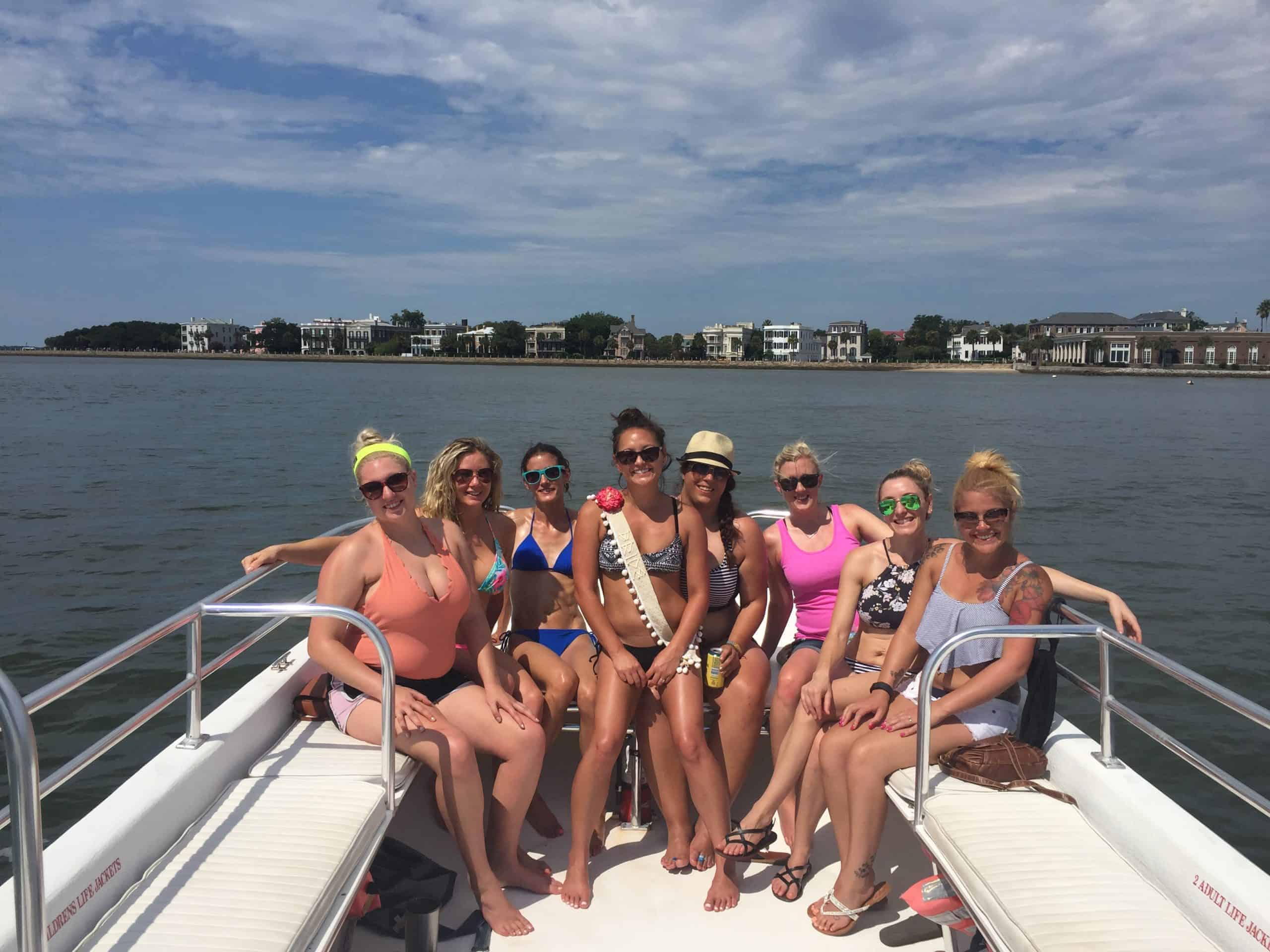 Group of women gathered on the boat, ready to swim. Charleston bachelorette party boat