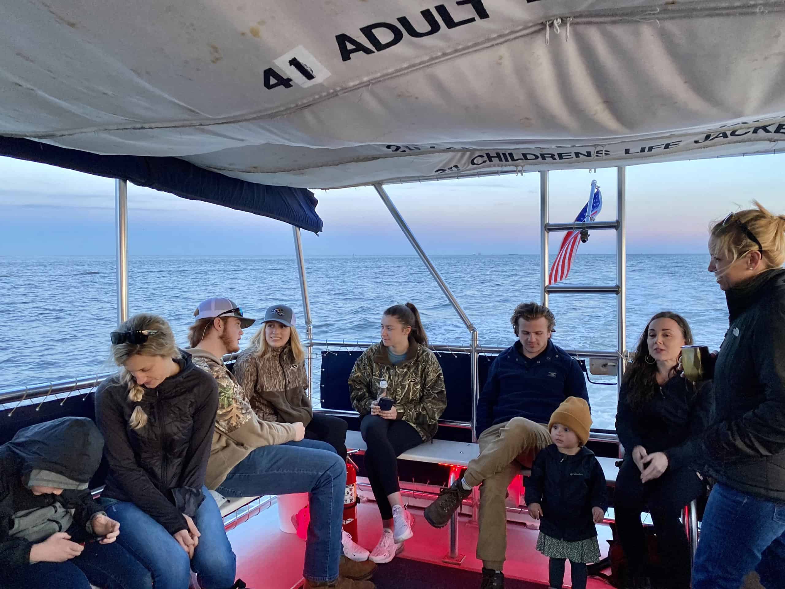 People of all ages chatting while they enjoy their boat ride together. Family boat charters Charleston, SC