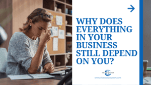 Founder sitting at desk overwhelmed by decisions routing through them — the founder bottleneck in a growing business.