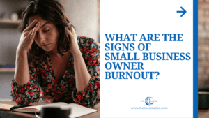 Small business owner at a desk late in the evening, showing signs of burnout from carrying the whole business.