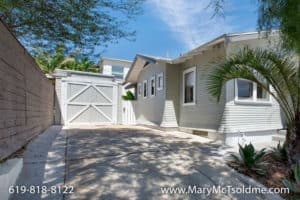 Light grey Craftsman-style home at 3164 Thorn St in North Park with a long concrete driveway and detached garage.