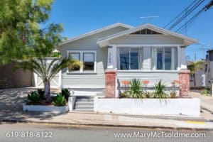 Light grey Craftsman bungalow at 3164 Thorn St in North Park with brick pillars, a raised white planter, and drought-tolerant succulents.