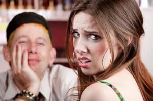 Woman on a date looking away from her date with a look of disgust.